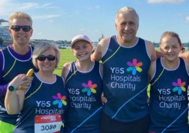 runners smiling in charity vests