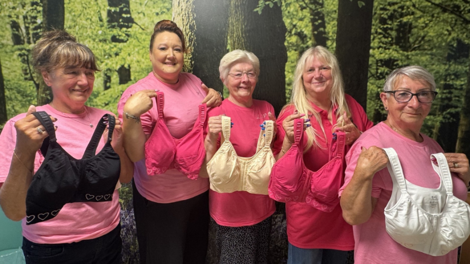 The Pink Ladies group holding up new bras