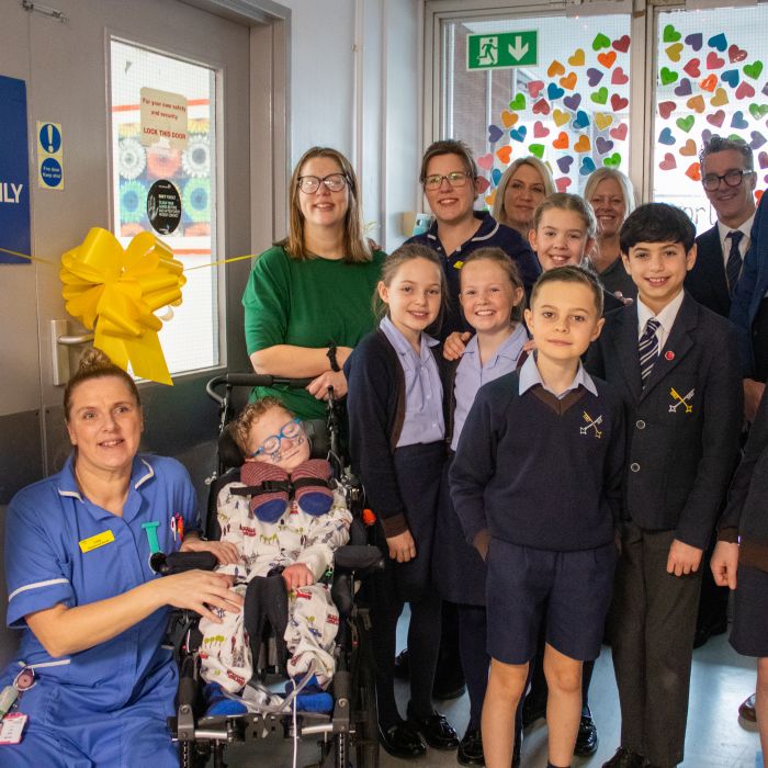 Children at the cutting the ribbon to open the parents room 