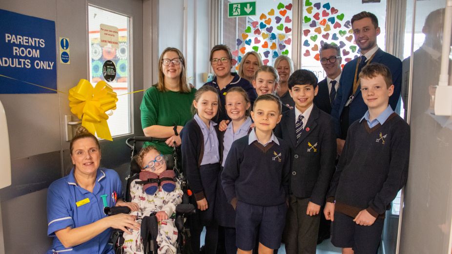 Children at the cutting the ribbon to open the parents room 
