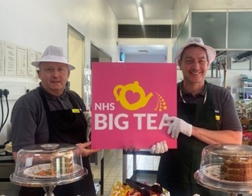 Staff holding sign