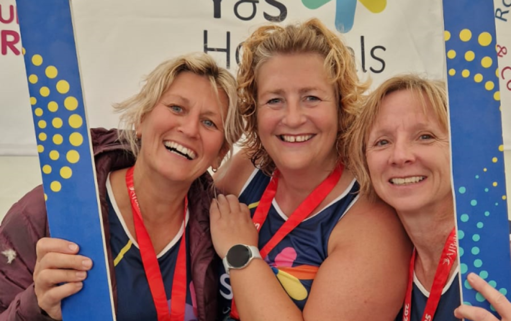 Staff wearing Christmas clothes and accessories, smiling