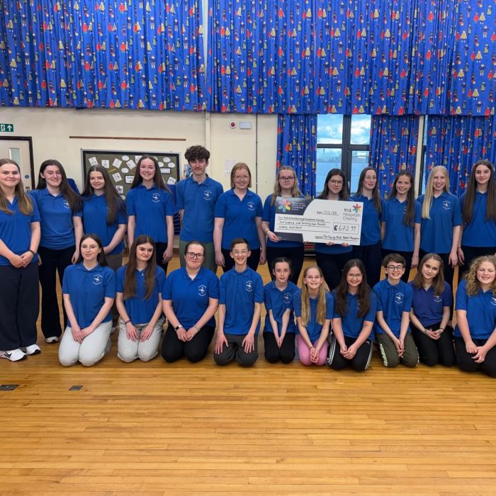 Haxby youth theatre club standing for a group picture holding a giant cheque