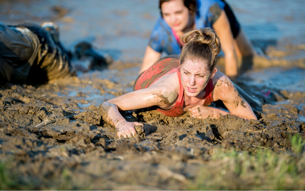 woman crawling through mud