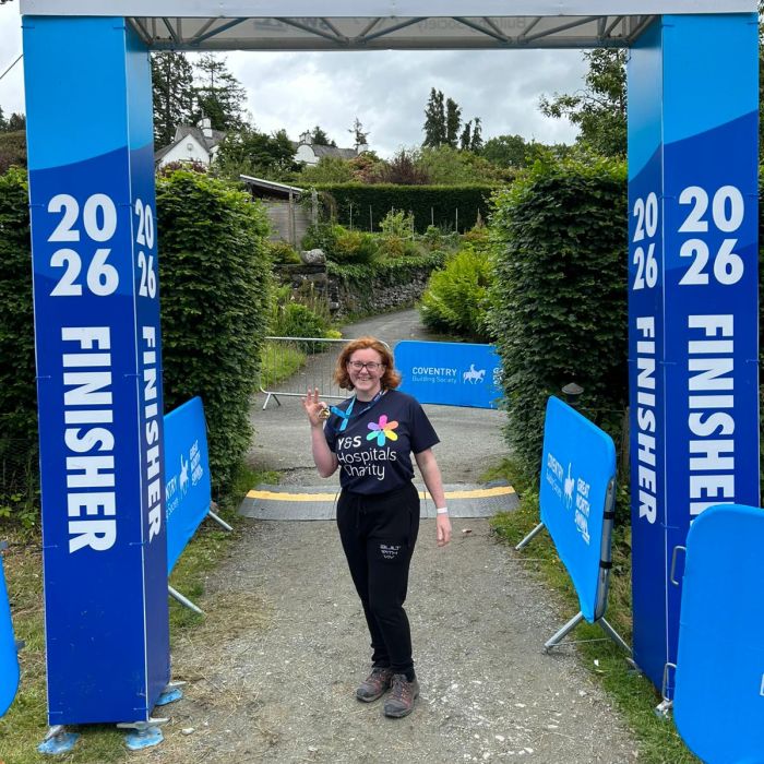 Woman holding a medal after completing the Great North Swim 