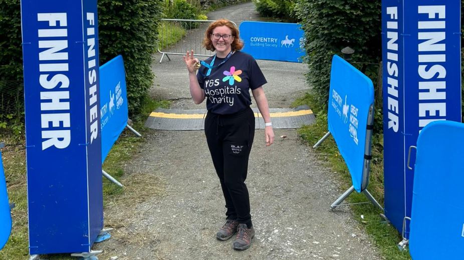 Woman holding a medal after completing the Great North Swim 