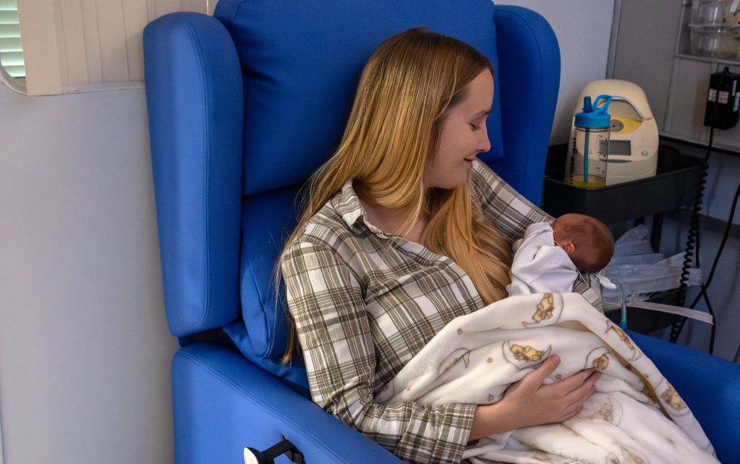 Mother holding baby in Neonatal Unit