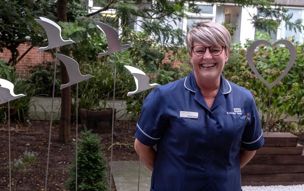 nurse smiling in hospital garden