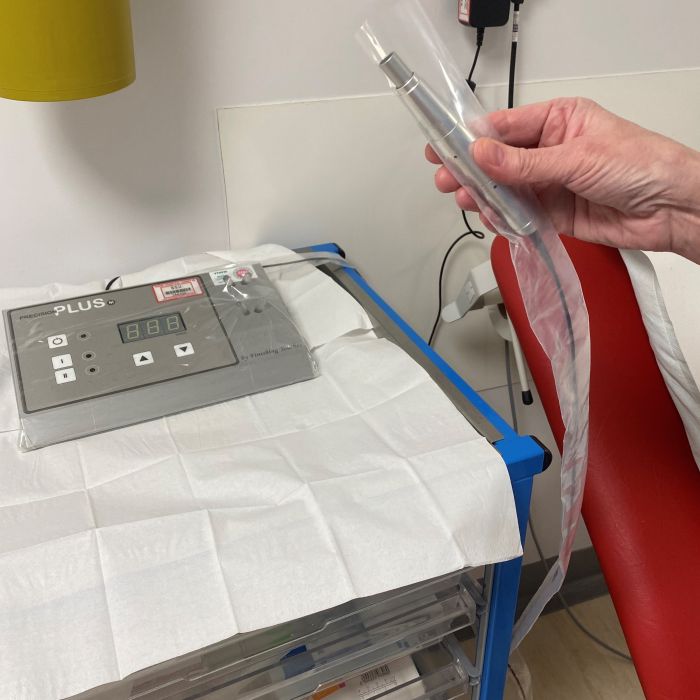 hand holding tattoo machine