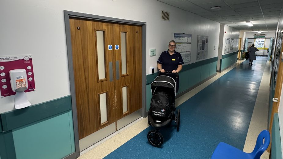Bereavement burse stood with pram in Hospital grounds