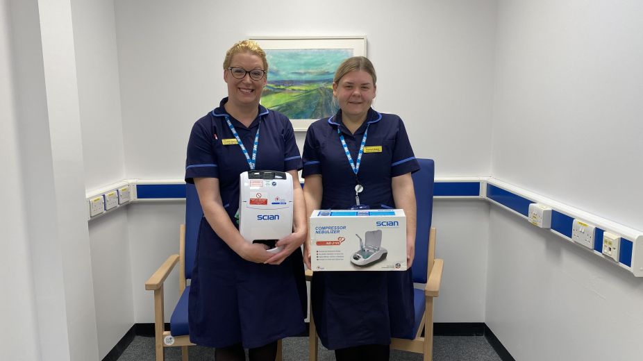 two nurses in uniform holding nebuliser equipment