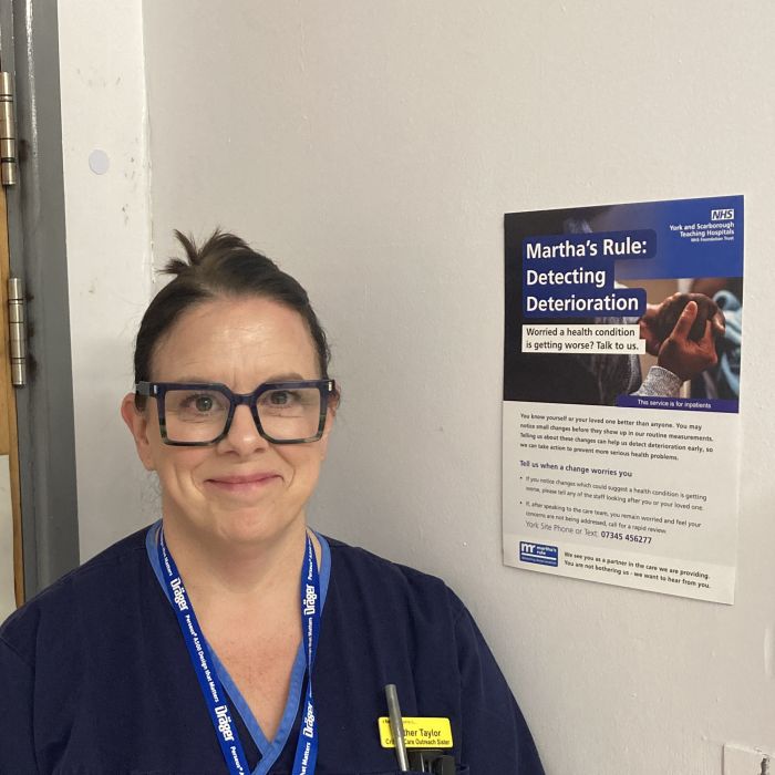 Nurse in uniform stood outside of ward