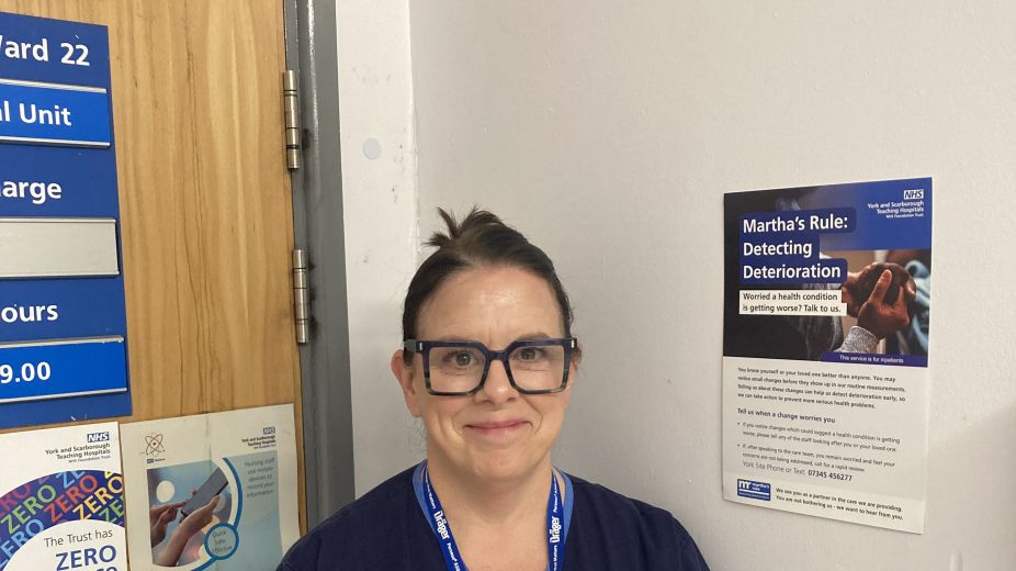 Nurse in uniform stood outside of ward
