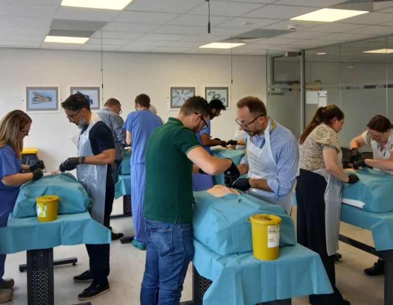 Medical staff doing medical training in a class room.